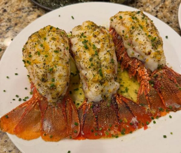 Grilled lobster tails with herb butter for an in-home dinner party