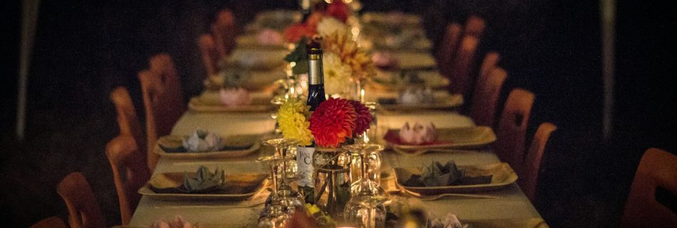 An elegant dining table set with flowers and candles for a holiday private chef dinner in Los Angeles