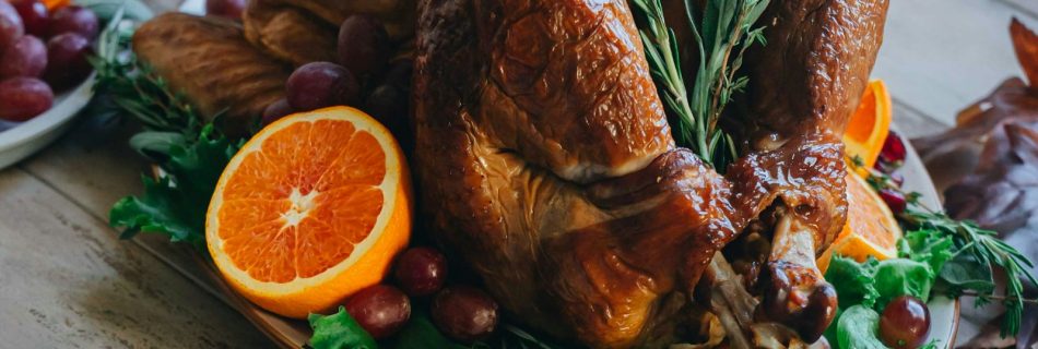 Golden roast turkey garnished with oranges and rosemary prepared by a Thanksgiving private chef in Los Angeles