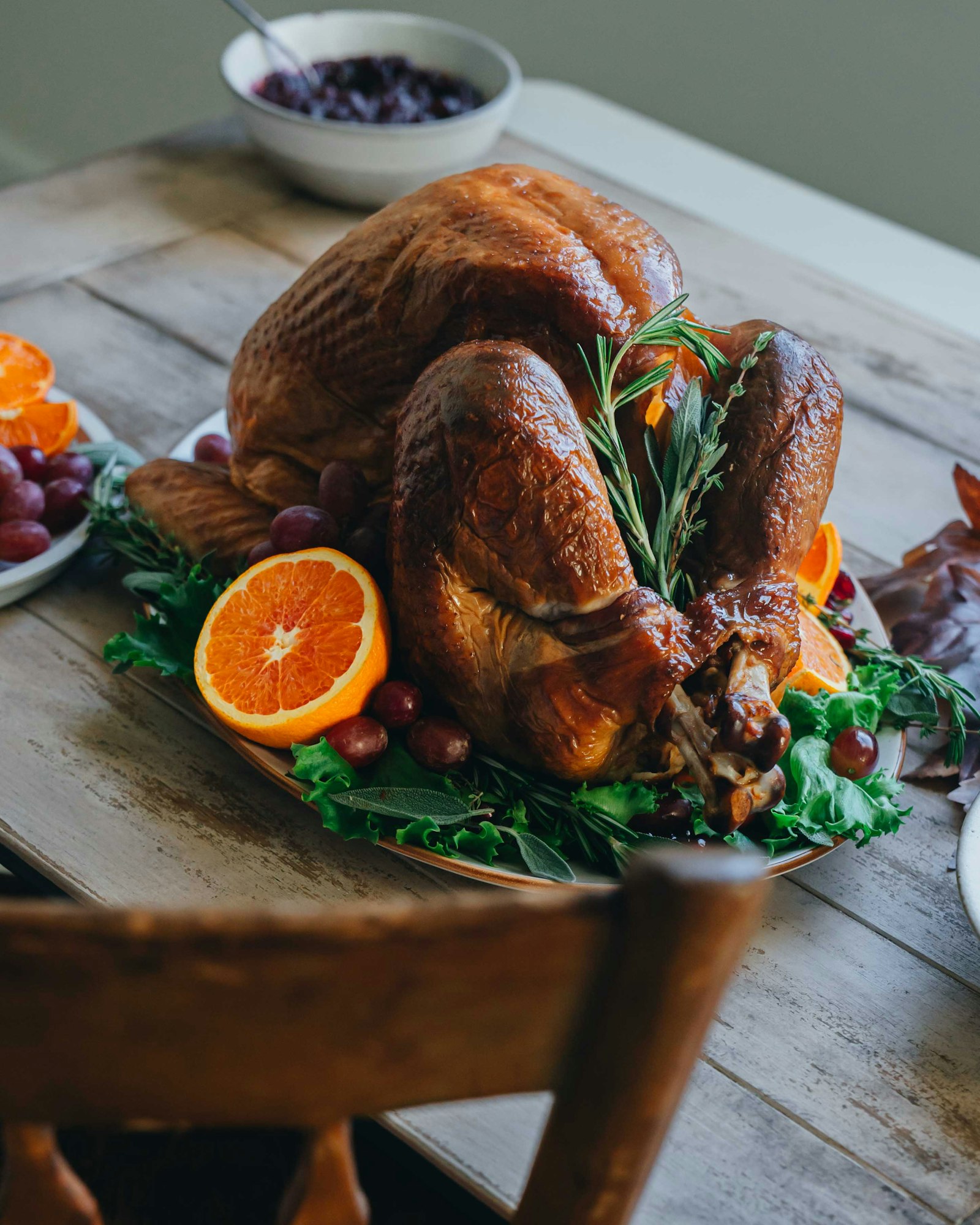 Golden roast turkey garnished with oranges and rosemary prepared by a Thanksgiving private chef in Los Angeles