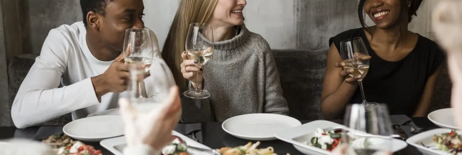Group of friends enjoying a private chef dinner with wine in Los Angeles