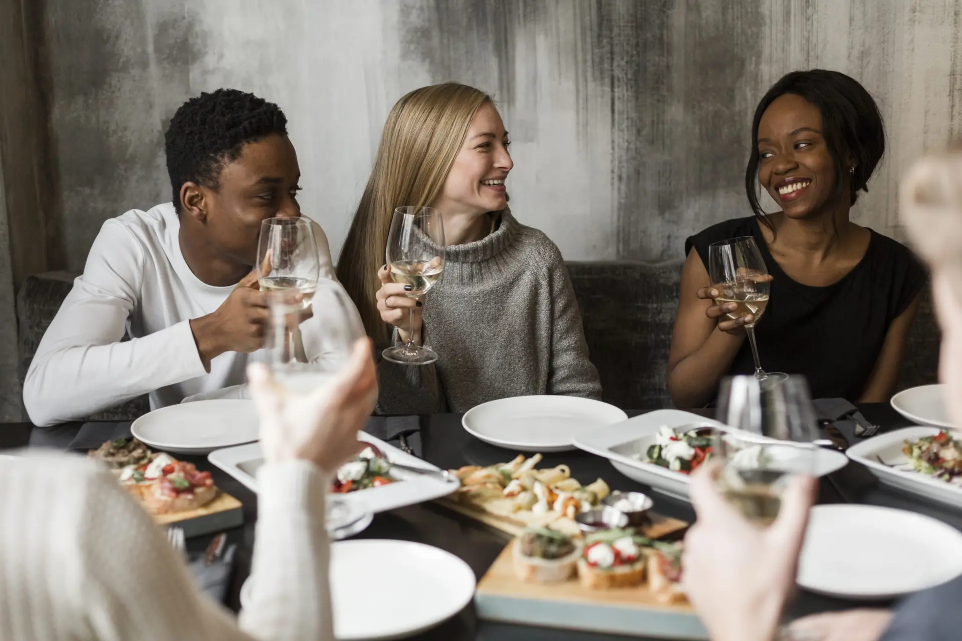 Group of friends enjoying a private chef dinner with wine in Los Angeles