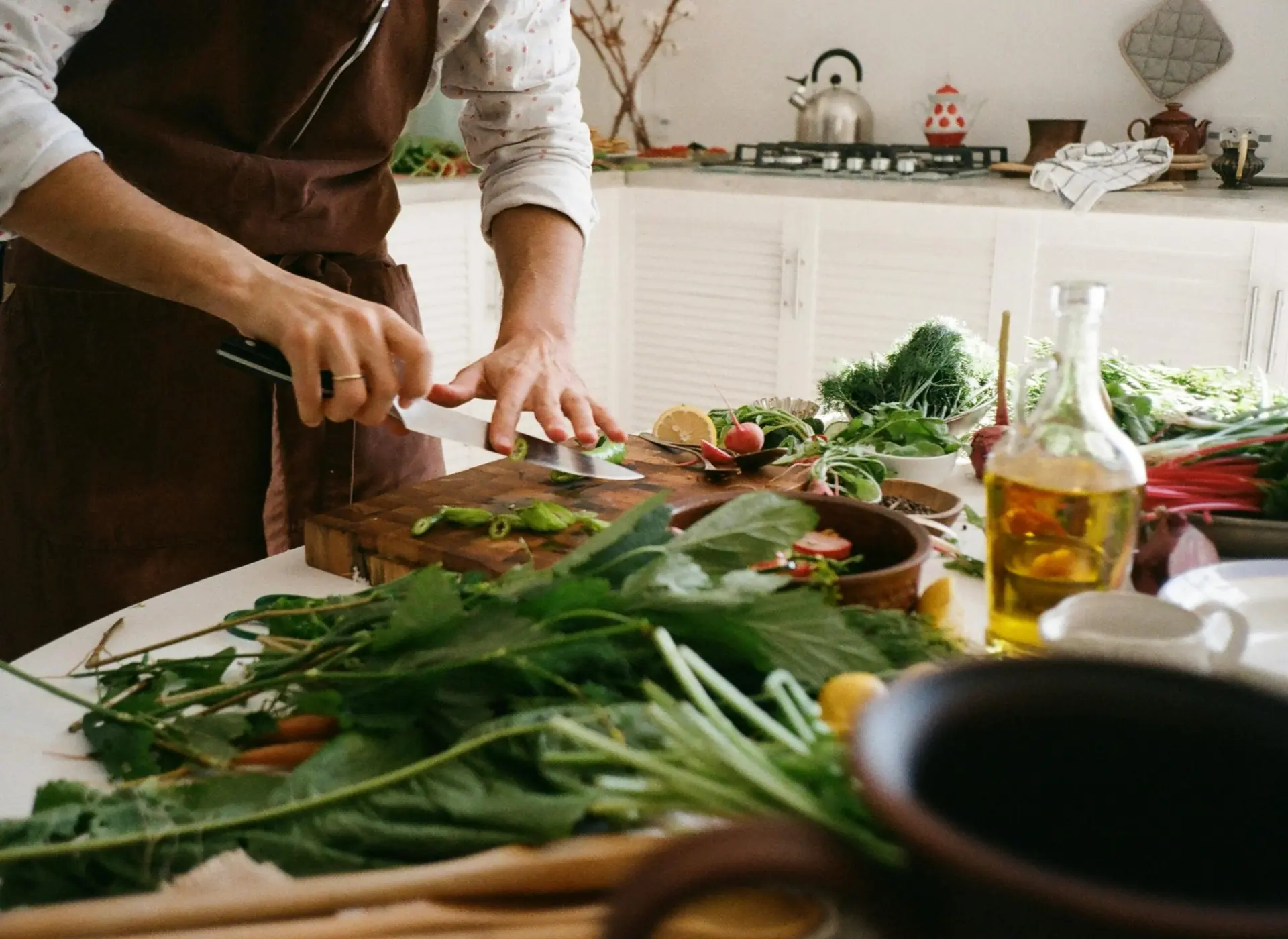 Private chef chopping fresh farmers market vegetables for a dinner in a Malibu home